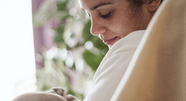 smiling mom with infant Mom enjoying baby after breastfeeding